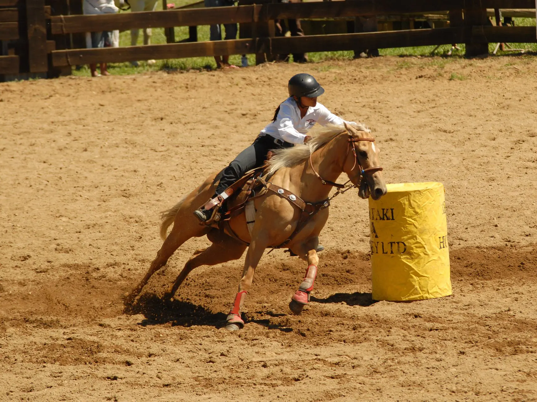 Rider barrel racing at high speed