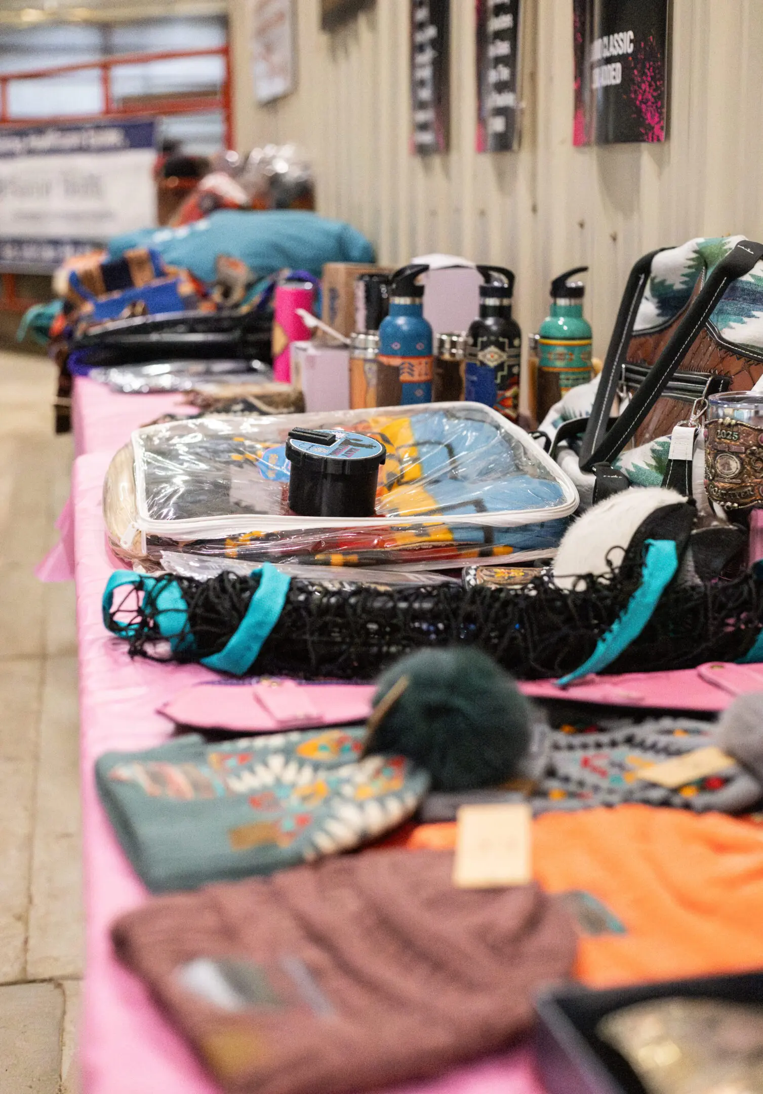 Colorful handmade crafts displayed on a table at a market.
